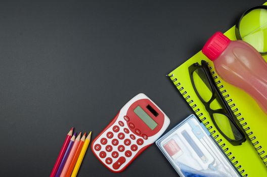 Various school supplies. studying, education and back to school concept. Black background and selective focus.