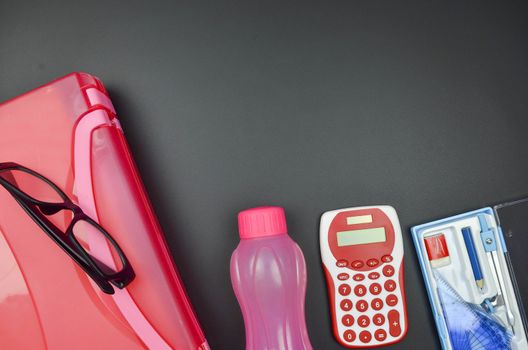 Various school supplies. studying, education and back to school concept. Black background and selective focus.