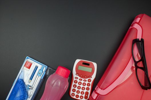 Various school supplies. studying, education and back to school concept. Black background and selective focus.