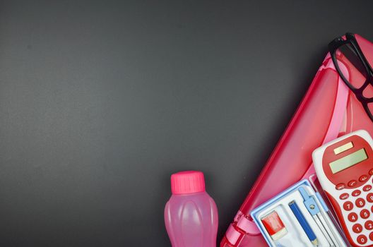 Various school supplies. studying, education and back to school concept. Black background and selective focus.