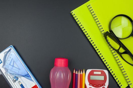 Various school supplies. studying, education and back to school concept. Black background and selective focus.