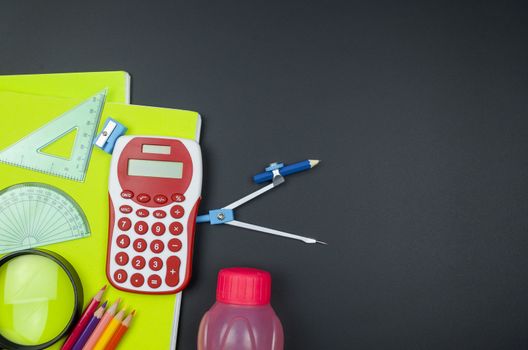 Various school supplies. studying, education and back to school concept. Black background and selective focus.
