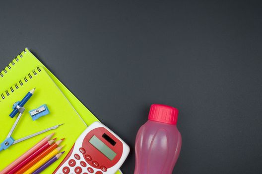 Various school supplies. studying, education and back to school concept. Black background and selective focus.