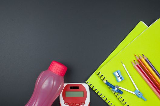 Various school supplies. studying, education and back to school concept. Black background and selective focus.