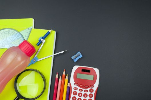 Various school supplies. studying, education and back to school concept. Black background and selective focus.