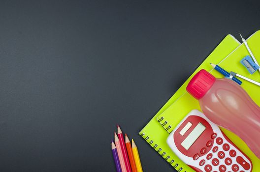 Various school supplies. studying, education and back to school concept. Black background and selective focus.