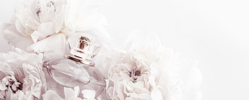 Chic fragrance bottle as luxe perfume product on background of peony flowers, parfum ad and beauty branding design