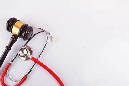 Judge hammer or gavel with stethoscope on white background. Justice and law concept. Selective focus.