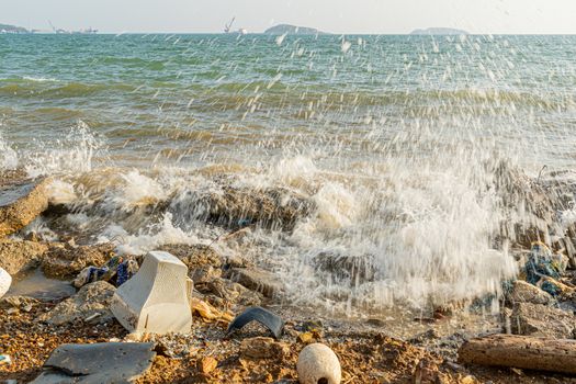 Electronic waste and foam become garbage on the beaches and birty sea water near the pier strong wind wave is a problem and pollution in Chonburi, Thailand