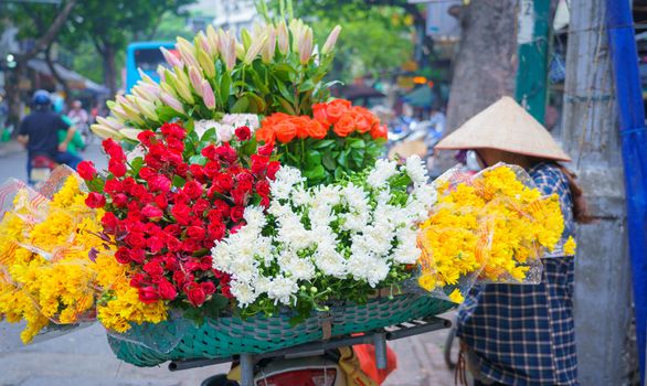 Flower market on bicycle on the road local market in HANOI VIETNAM VOVworld. to consist of Lilly, White rose, spike flower, Marigold