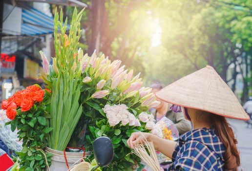 Flower market on bicycle on the road local market in HANOI VIETNAM VOVworld. to consist of Lilly, White rose, spike flower, Marigold