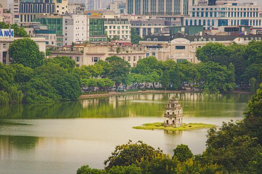 OLD QUARTER, HANOI/VIETNAM - JULY 16: City and top view of The Huc bridge and Ngoc Son temple on 07 16 2019 in Lake of the Returned Sword, Hoan Kiem Lake, Turtle Tower. Cities with haze problems
