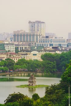 OLD QUARTER, HANOI/VIETNAM - JULY 16: City and top view of The Huc bridge and Ngoc Son temple on 07 16 2019 in Lake of the Returned Sword, Hoan Kiem Lake, Turtle Tower. Cities with haze problems