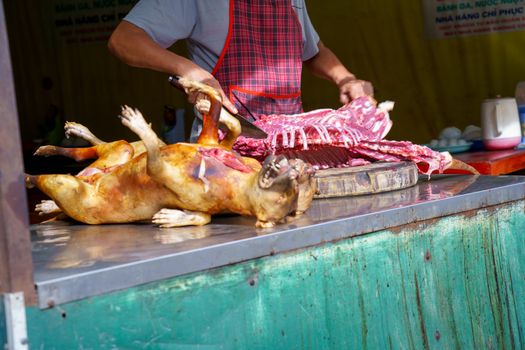 Man Dissected, pay Dog meat Dead body selling a grilled for barbecue Street food of Vietnam. Food is difficult.