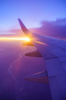 Beautiful sunset, sky on the top view, airplane flying view from inside window and cloud, sun down background aircraft of Traveling.