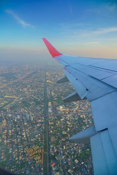 View from inside window Airplane airliner aircraft The plane, sky on the top view  flying cloud old city background aircraft of Traveling.