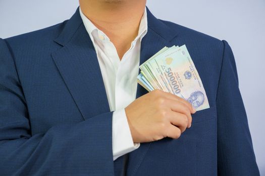 Money in Vietnam hold on hand business man wearing a blue suit (Socialist Republic Of Vietnam), Dong, VND, Pay, exchange money vietnamese on white background.