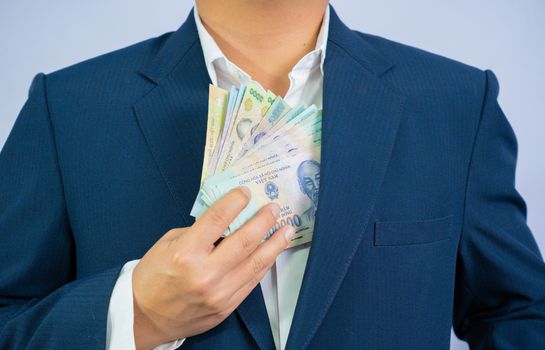 Money in Vietnam hold on hand business man wearing a blue suit (Socialist Republic Of Vietnam), Dong, VND, Pay, exchange money vietnamese on white background.