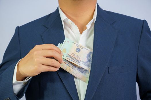 Money in Vietnam hold on hand business man wearing a blue suit (Socialist Republic Of Vietnam), Dong, VND, Pay, exchange money vietnamese on white background.