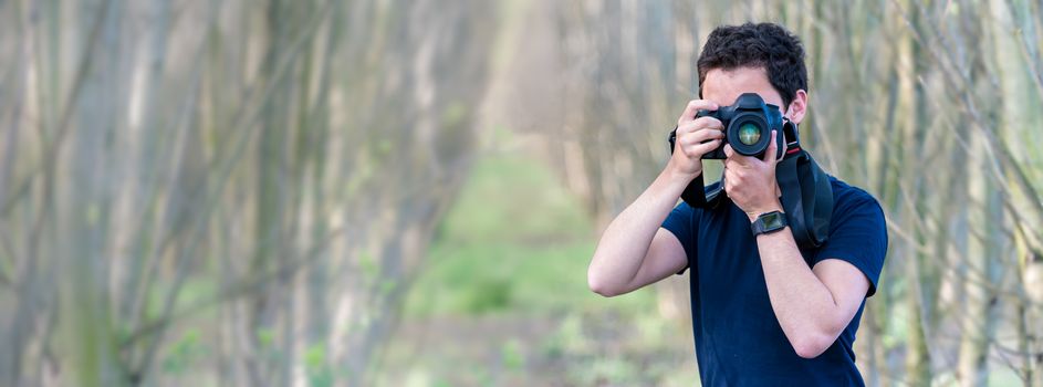 young man photographer in nature. copy space