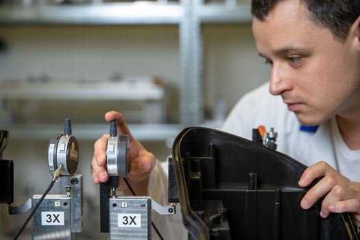 Scientists checking apparatus for accurate 3D measurements in a research laboratory.