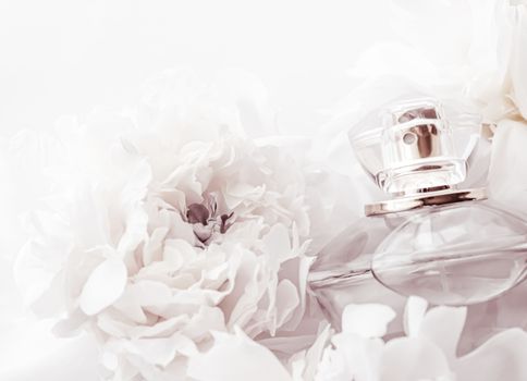 Chic fragrance bottle as luxe perfume product on background of peony flowers, parfum ad and beauty branding design