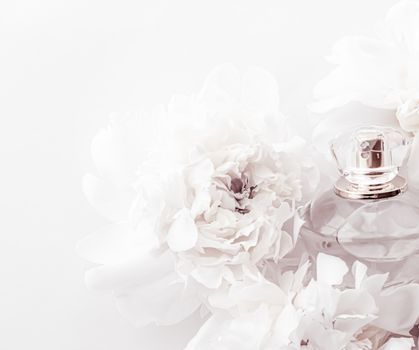 Chic fragrance bottle as luxe perfume product on background of peony flowers, parfum ad and beauty branding design