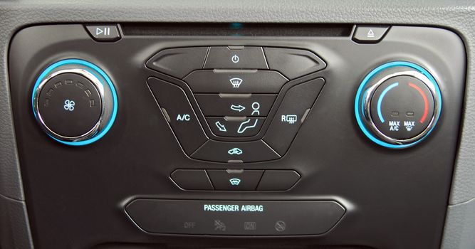 manual switches the air conditioning on the dashboard of the car