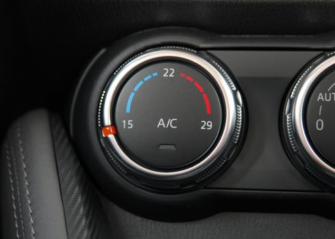 manual switches the air conditioning on the dashboard of the car
