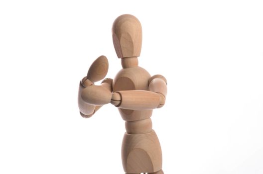 Wooden figure mannequin posing in action isolated on white background.