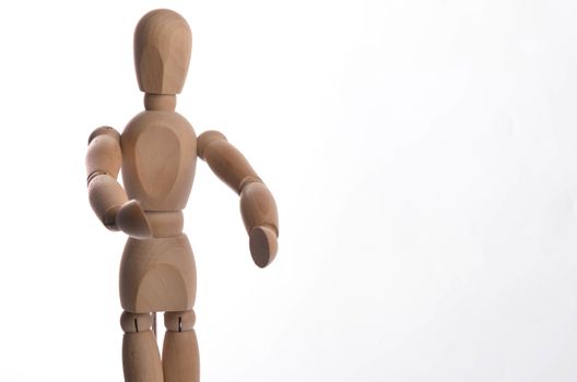 Wooden figure mannequin posing in action isolated on white background.