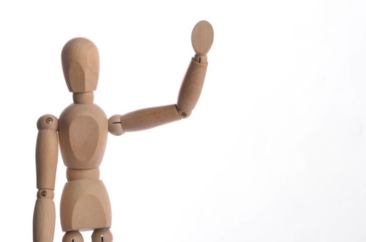 Wooden figure mannequin posing in action isolated on white background.