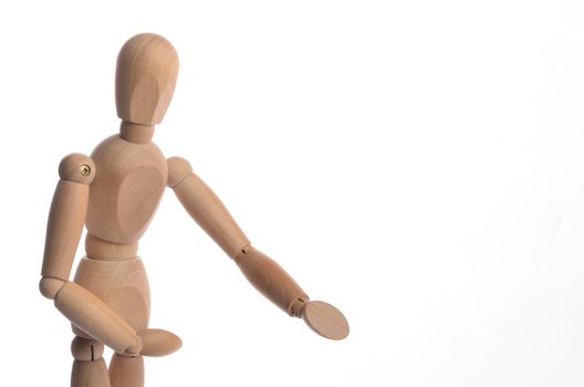 Wooden figure mannequin posing in action isolated on white background.