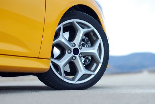 aluminum car wheel with a tire on a sports car