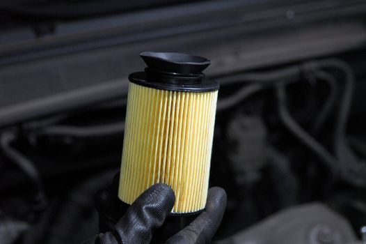 Repairman holding an new oil filter