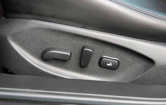 Buttons for adjusting seat position. Car interior detail