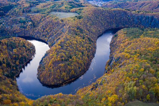 Beautiful Vyhlidka Maj, Lookout Maj, near Teletin, Czech Republic. Meander of the river Vltava surrounded by colorful autumn forest viewed from above. Tourist attraction in Czech landscape. Czechia.