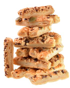 Mini seeded straws topped with cheese and seeds sunflower, pumpkin, linseeds isolated on a white background.