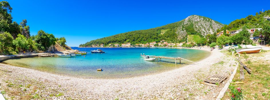 TRSTENIK, CROATIA - JUNE 25, 2015: Panoramic view of the bay and the village, with locals and tourists, in Trstenik, Croatia