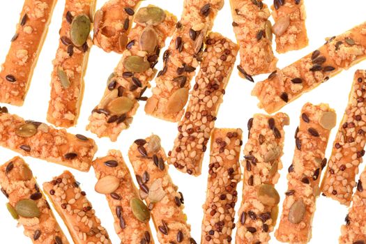 Mini seeded straws topped with cheese and seeds sunflower, pumpkin, linseeds isolated on a white background.