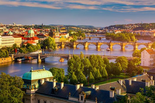 Scenic view of the Old Town pier architecture and Charles Bridge over Vltava river in Prague, Czech Republic. Prague iconic Charles Bridge (Karluv Most) and Old Town Bridge Tower at sunset, Czechia.