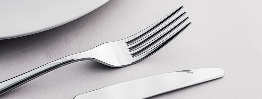 Empty plate and cutlery as mockup set on white background, top tableware for chef table decor and menu branding design