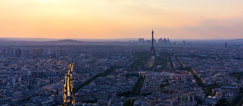 Panoramic aerial view of Paris, Eiffel Tower and La Defense business district. Aerial view of Paris at sunset. Panoramic view of Paris skyline with Eiffel Tower and La Defense. Paris, France. 