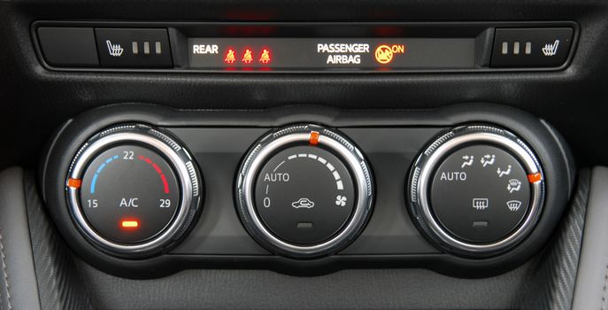 manual switches the air conditioning on the dashboard of the car