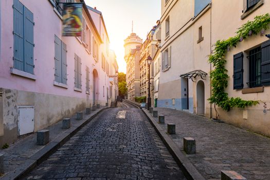Montmartre district of Paris. Houses on narrow road in Montmartre district of Paris. View of cozy street in quarter Montmartre in Paris, France. Architecture and landmarks of Paris. Postcard of Paris.