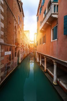 View of the street canal in Venice, Italy. Colorful facades of old Venice houses. Venice is a popular tourist destination of Europe. Venice, Italy.