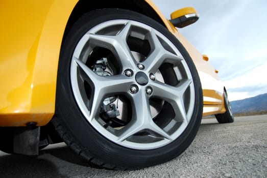 aluminum car wheel with a tire on a sports car