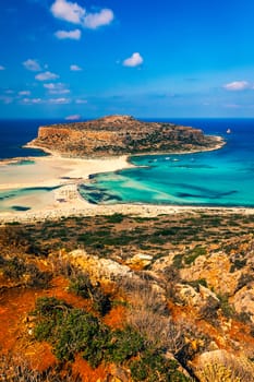 Fantastic panorama of Balos Lagoon and Gramvousa island on Crete, Greece. Cap tigani in the center. Balos beach on Crete island, Greece. Tourists relax and bath in crystal clear water of Balos beach.