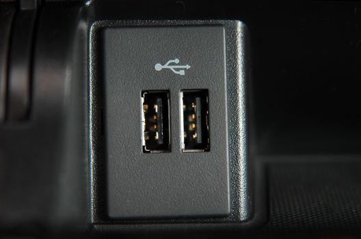 two usb ports on the dashboard of a modern passenger car