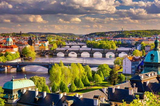 Scenic view of the Old Town pier architecture and Charles Bridge over Vltava river in Prague, Czech Republic. Prague iconic Charles Bridge (Karluv Most) and Old Town Bridge Tower at sunset, Czechia.